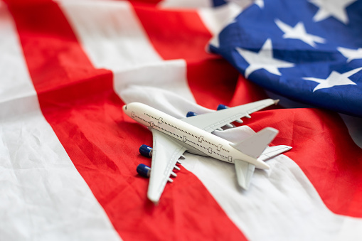 United states flight background. Airplane toy on a starts and stripes flag. High quality photo