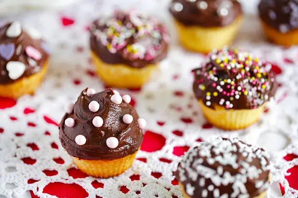 Photo of Cupcakes small, covered with chocolate and sprinkles