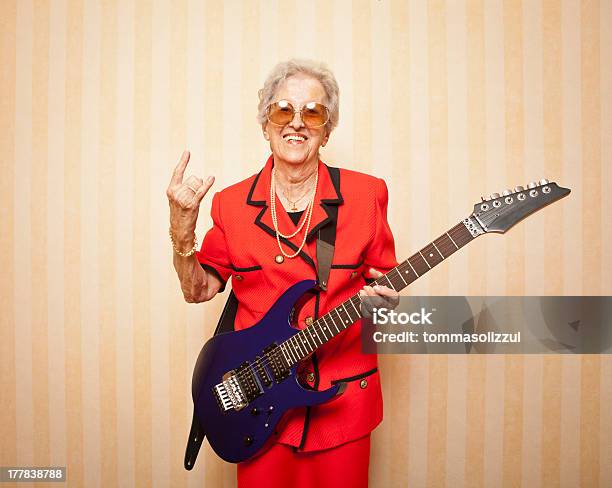 Older Woman In A Red Suit And With An Electric Guitar Stock Photo - Download Image Now