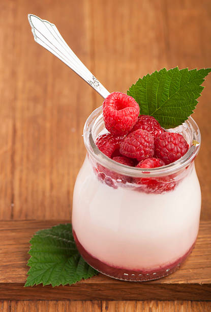 istock White yogurt in a glass jar with raspberry 177838860
