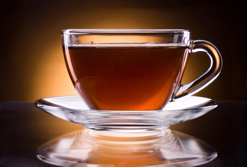 Cup of black tea isolated on a dark background