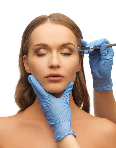 istock woman face and beautician hands 177839263
