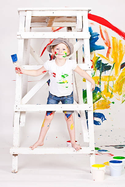 istock girl in a cap with paints 177839483