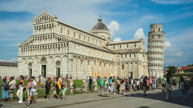 Time lapse of Crowd of People tourism walking and sightseeing attraction at Leaning Tower of Pisa and Pisa Cathedral with perfect blue sky and cloud in Pisa, Tuscany, Italy