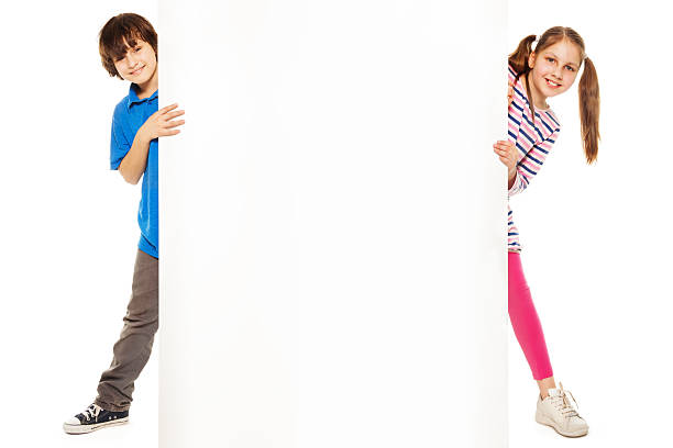 Two kids showing new blank advertising Handsome boy and beautiful girl showing blank white board for advertising to be inserted number 10 sign stock pictures, royalty-free photos & images