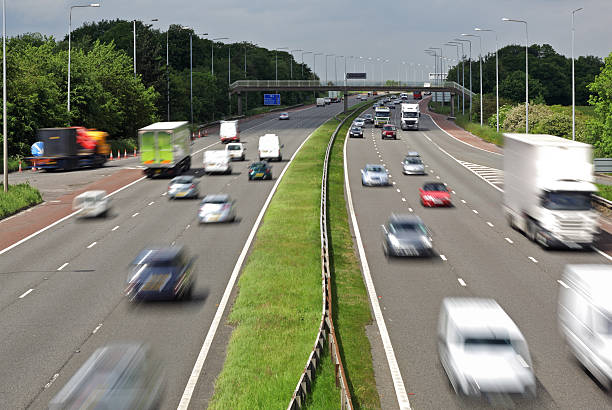 Motorway traffic Heavy traffic moving at speed on the M6 motorway in England traffic car traffic jam uk stock pictures, royalty-free photos & images