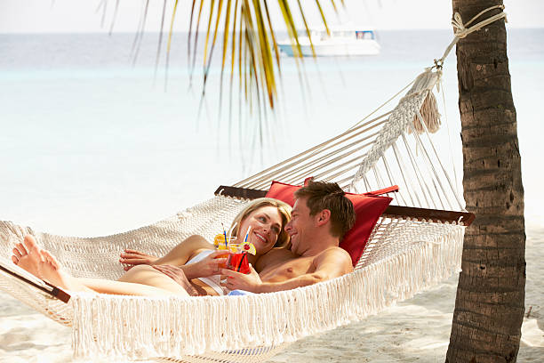 istock Romantic Couple Relaxing In Beach Hammock 177841078