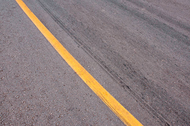 Tire Marks Rubber tyre tracks on a tar road street skid marks stock pictures, royalty-free photos & images