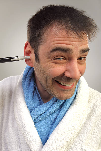 istock Man removing hair from his ear 177842099