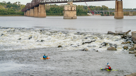 Great Falls, Virginia, USA - June 3, 2021.  An experienced kayaker rides the whitewaters.