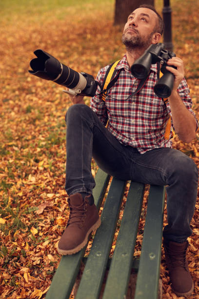 istock Man using binoculars and camera for bird and animal watching in nature. 1778424245