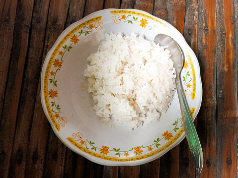 white rice on a plate with Bamboo table. Surabaya, East Java, Indonesia. February 02, 2023