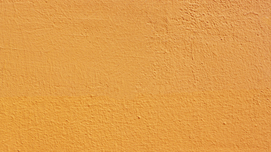 Texture of time-damaged paint. \nTexture of a brown wall close-up.