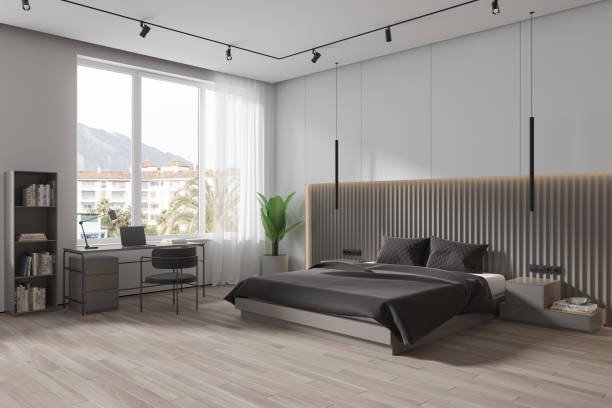 istock White hotel bedroom interior with bed and work corner, panoramic window 1778430314