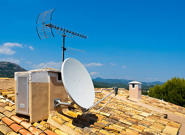 Antenna on a Tile Roof Antenna on a Tile Roof parabol stock pictures, royalty-free photos & images