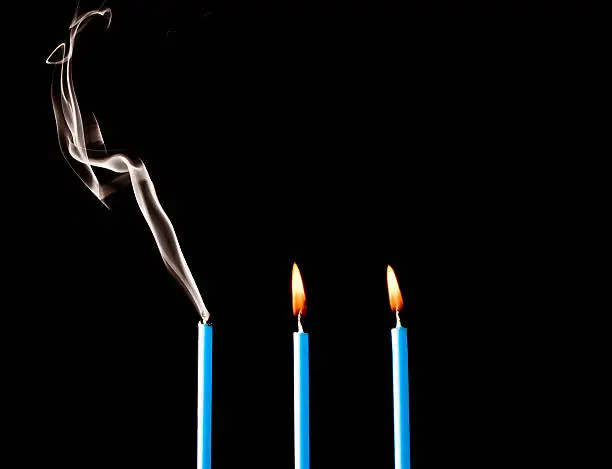 Photo of Three Candles Lit and Smoking