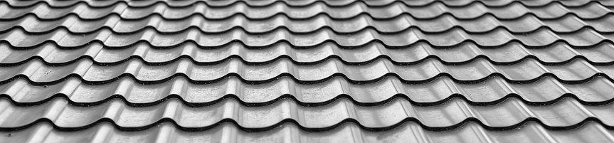 Background of wavy metallic gray tiles for roofing.