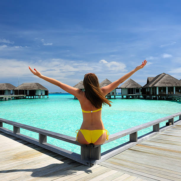 istock Woman on a beach jetty at Maldives 177843919