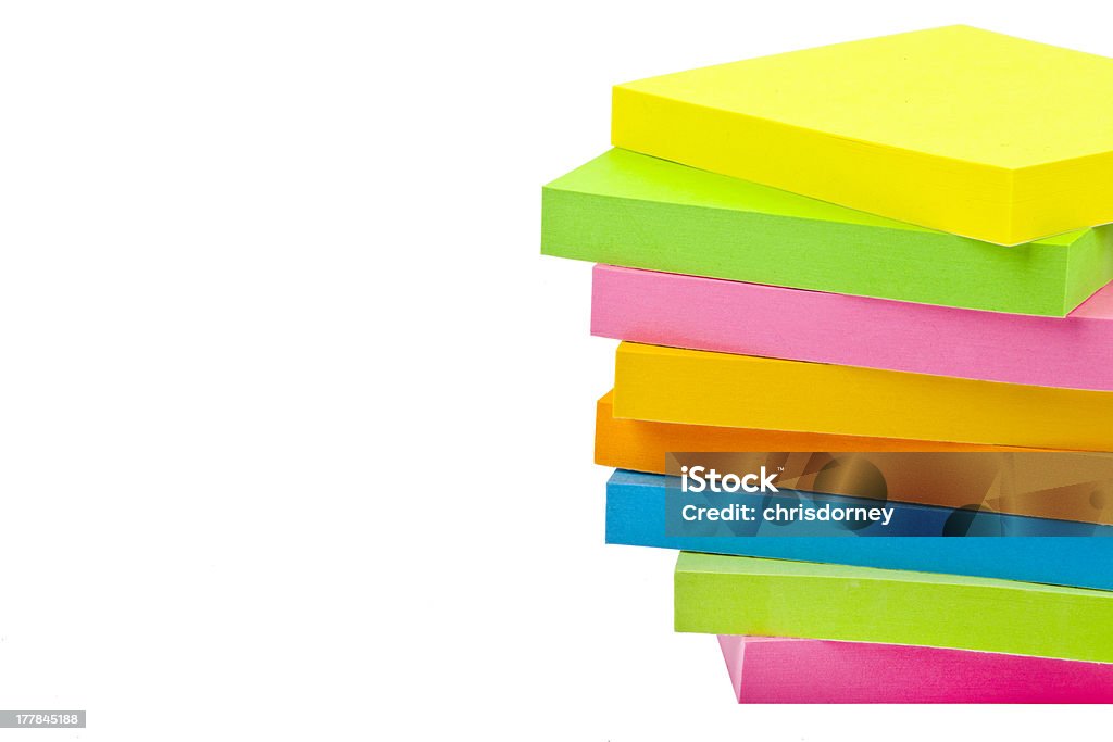 Stack of Sticky Note Pads Stack of Sticky Note Pads over a white background. Adhesive Note Stock Photo