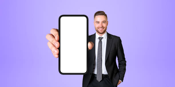 istock Smiling man showing smartphone with blank display 1778456066