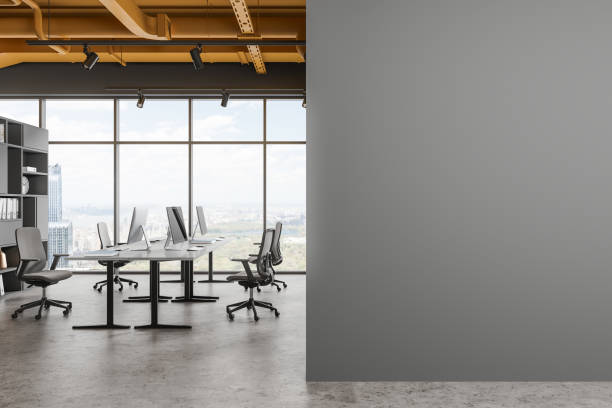 istock Grey office interior with pc desktop and shelf, panoramic window. Mock up wall 1778457754