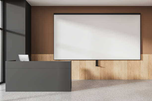 istock Stylish class room interior with teacher desk and mock up projection screen 1778471340