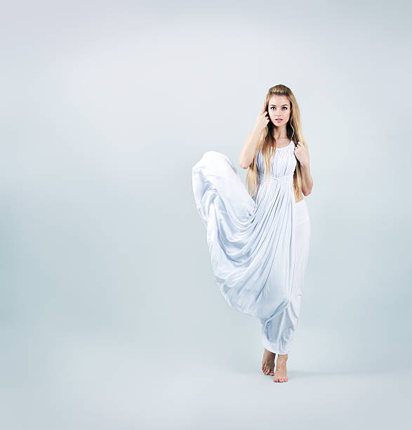 Blonde Woman in Waving White Dress stock photo