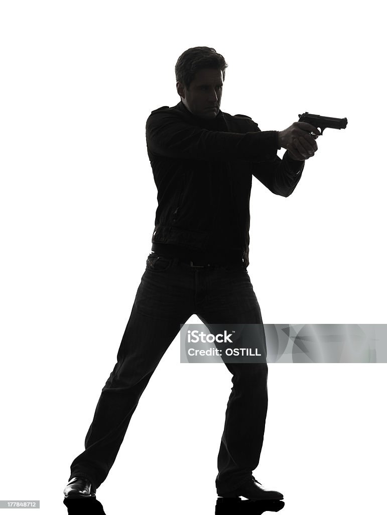 Uomo in Pistola puntamento killer policeman in piedi modello - Foto stock royalty-free di Uomini