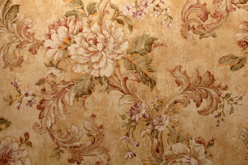 Vintage golden run-down victorian wallpaper with baroque floral pattern