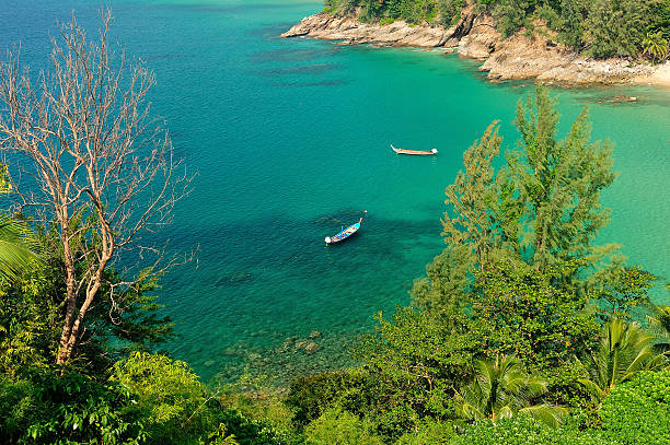 istock traditional longtail boat floats in perfect crystal clear water. 177849656