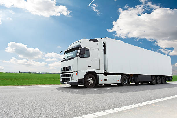 white lorry with trailer over blue sky stock photo