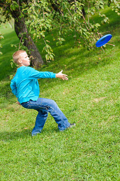 Little boy playing frisbee stock photo