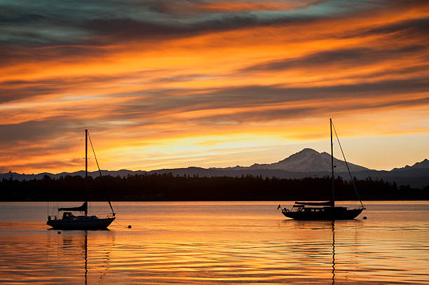 Seattle, USA - Jun 26, 2023: Sunset over Elliott Bay on the waterfront with the Seattle Tall Sailing Ship The Bay Lady.
