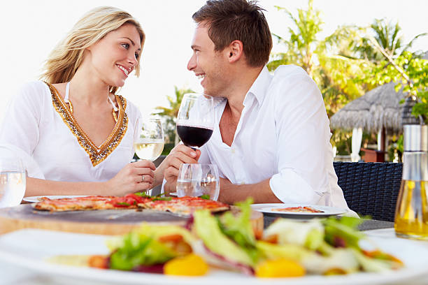 Romantic couple eating at outdoor restaurant