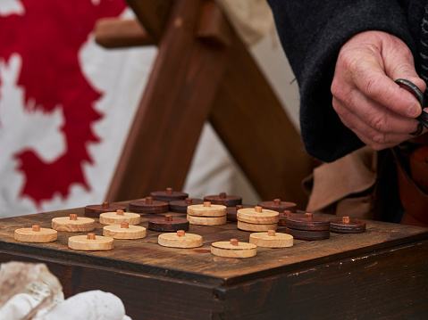 A photo of a man playing medieval checkers
