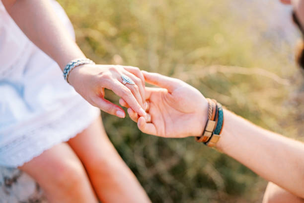 istock Groom holds bride hand in his own. Cropped. Faceless 1778526262