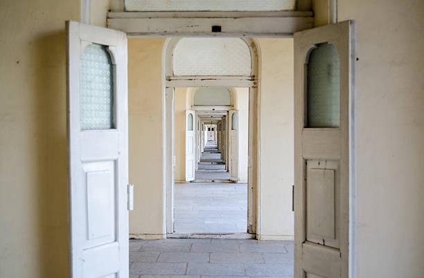 Marienbad, Czech Republic - August 10, 2014: View to the famous arcade in the spa town Marienbad. People are strolling and sitting inside of the beautiful building. The architecture is interesting because of light and shadow. The columns in the colonnade are made from iron. The Arcade was built in 1869.