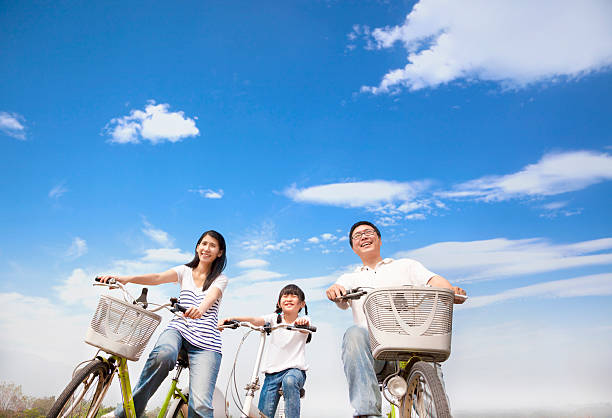 happy family riding bicycle with cloud background