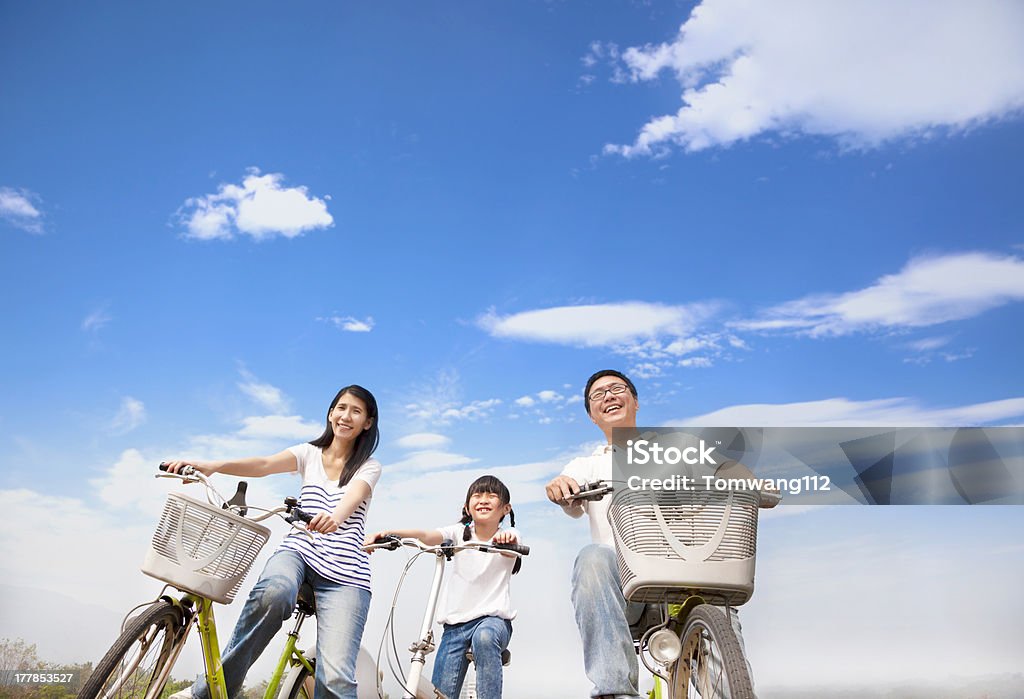 happy family riding bicycle with cloud background Family Stock Photo