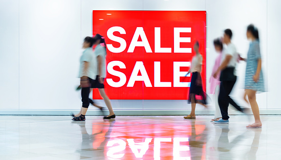 Sale sign on the wall of shopping mall