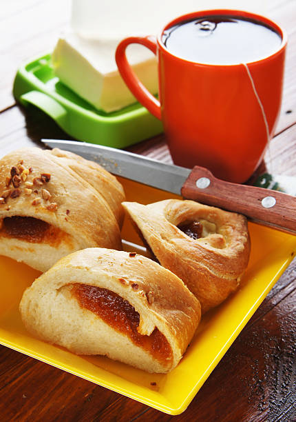 istock Bun with jam and cup of tea 177853959
