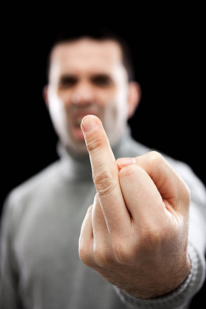 Man giving the finger (focus on hand) stock photo
