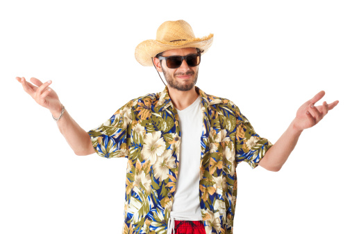 a young, attractive male in a colorful outfit ready to travel as a stereotype tourist