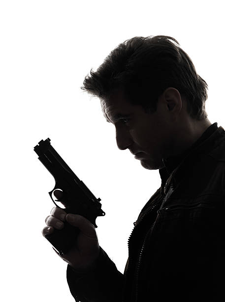 istock man killer policeman holding gun portrait silhouette 177855815