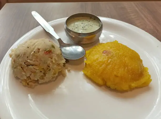 A closeup picture of a South Indian breakfast called chow chow bath on a white plate.