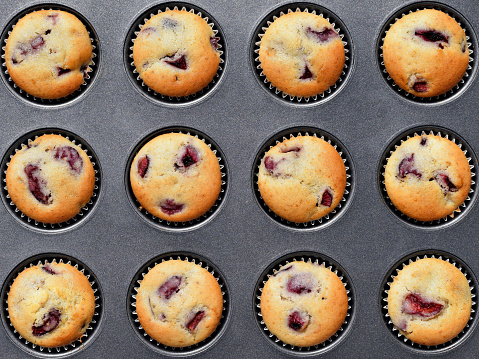 Homemade blueberry muffins in baking mold .Flower decoration