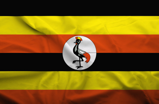 Waving flag of Uganda. Flag has real fabric texture.