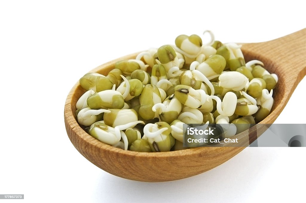 Sprouted mung beans Sprouted mung beans in wooden spoon isolated on white Bean Stock Photo