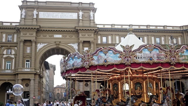 Gate of Republic Square Piazza della Repubblica in Florence and Antica Giostra carousel, famous old town in the city center of Florence, Carousel Horses in Piazza della Repubblica in Florence in Tuscany