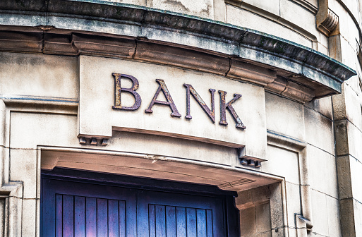 An old fashioned bank sign on the exterior of a building in Manchester, England.
